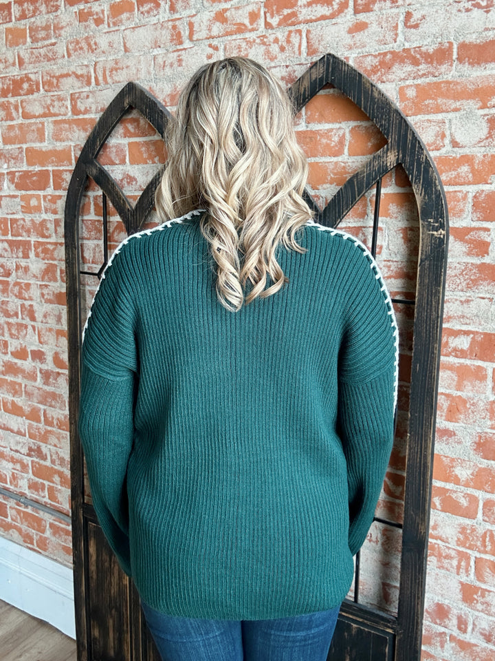 A Silent Night Hunter Green Exposed Seam Sweater